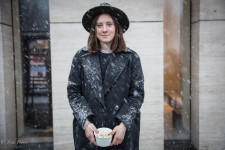 Polina was standing outside a fashionable mall during a heavy snowfall.