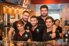 Pierre with co-workers inside their Yerevan-based cafe.