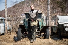 Dmitry standing in front of the 1938 GAZ automobile, one of some 20 old cars he has collected over the years.