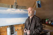 Vladimir standing next to one of his paintings-in-progress.
