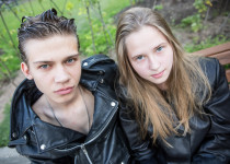 Timofei and Anna, 17, were sitting at a park in Moscow dressed in black leather coats.