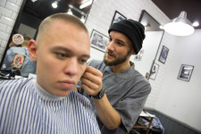 Danil at work at the barbershop.